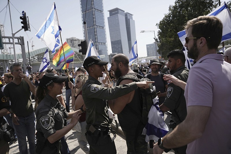 Israeli paramilitary Border Police face off with an Israeli protesting against plans by Prime Minister Benjamin Netanyahu’s new government to overhaul the judicial system, Wednesday in Tel Aviv, Israel.
(AP/Oded Balilty)