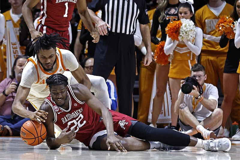 Arkansas forward Makhel Mitchell (bottom) battles for a loose ball with Tennessee forward Jonas Aidoo during the second half of Tuesday’s SEC men’s basketball game in Knoxville, Tenn. The Razorbacks lost 75-57 and have dropped four of their past six games.
(AP/Wade Payne)