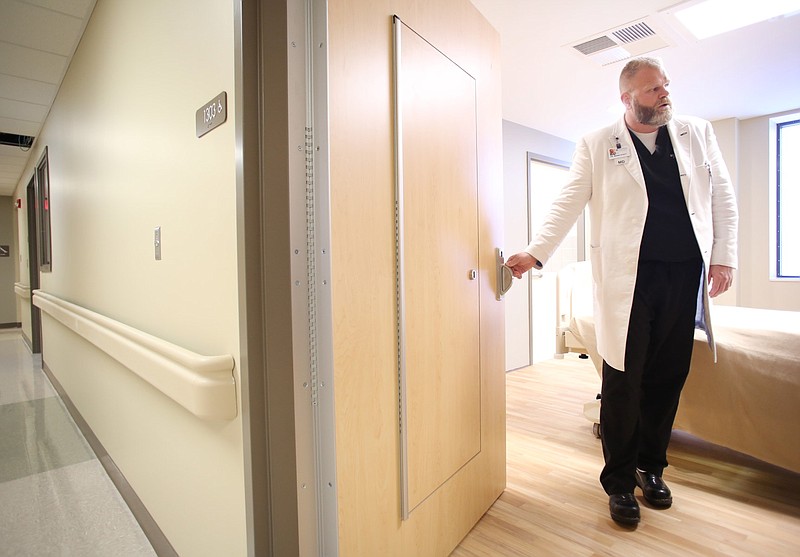 FILE — Dr. Brian Hyatt shows the additional access safety door in one of the medical psychiatric rooms at Northwest Medical Center in Springdale in this March 13, 2018 file photo. (NWA Democrat-Gazette/David Gottschalk)