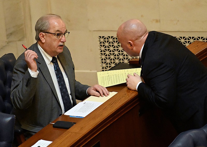 Sen. Kim Hammer (left), R-Benton, converses with Sen. Matt McKee, R-Pearcy, during the Senate session at the state Capitol in Little Rock in Wednesday. Read bill at arkansasonline.com/32sb307/.
(Arkansas Democrat-Gazette/Staci Vandagriff)