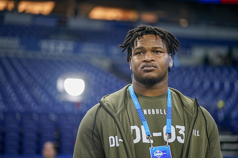 AP photo by Darron Cummings / Defensive lineman Jalen Carter, who starred at Georgia, watches as fellow draft prospects warm up on the field at Lucas Oil Stadium during the NFL scouting combine Thursday in Indianapolis.