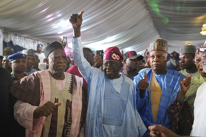 Bola Tinubu (center) of the All Progressives Congress celebrates with supporters at the party’s campaign headquarters Wednesday in Abuja, Nigeria, after being declared the winner of the presidential election. Video online arkansasonline.com/303nigeria/.
(AP/Ben Curtis)