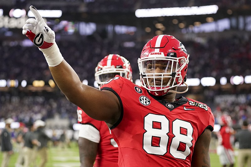 FILE - Georgia defensive lineman Jalen Carter (88) waves to the crowd before the national championship NCAA College Football Playoff game between Georgia and TCU, Monday, Jan. 9, 2023, in Inglewood, Calif. Georgia defensive tackle Jalen Carter, projected as one of the top players in next month's NFL draft, has been charged with reckless driving and racing in conjunction with the crash that killed offensive lineman Devin Willock and a recruiting staff member.(AP Photo/Ashley Landis)