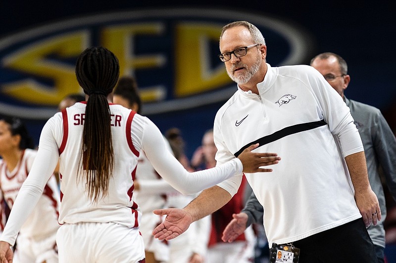 Arkansas head coach Mike Neighbors congratulates player Samara Spencer (2) after an NCAA college basketball game against Missouri in the Southeastern Conference women's tournament in Greenville, S.C., Thursday, March 2, 2023. (AP Photo/Mic Smith)