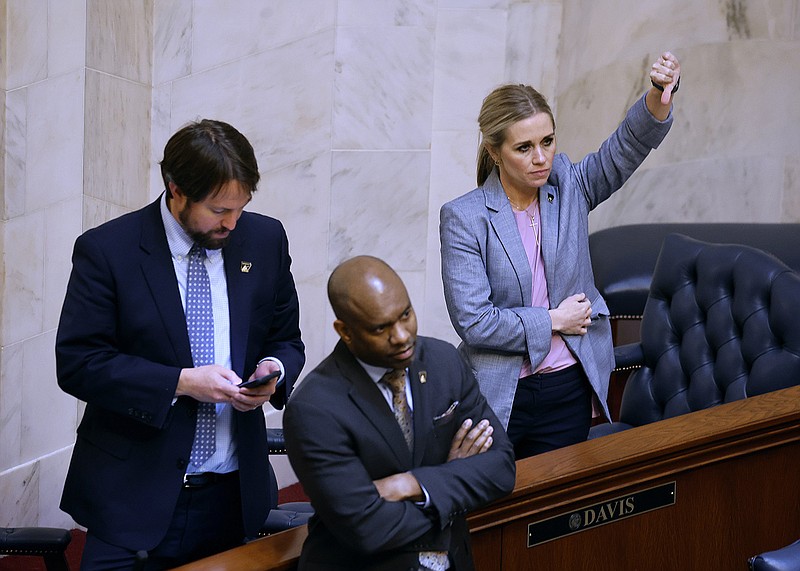 Sen. Breanne Davis (right), R-Russellville, votes against House Bill 1410, which would revise child labor laws, as Sen. Frederick Love (center), D-Mabelvale, and Sen. Clarke Tucker (left), D-Little Rock, look on during the Senate session on Thursday at the state Capitol in Little Rock.
(Arkansas Democrat-Gazette/Thomas Metthe)