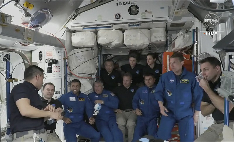 Astronauts gather during the welcoming ceremony Friday on the International Space Station.
(AP/NASA TV)