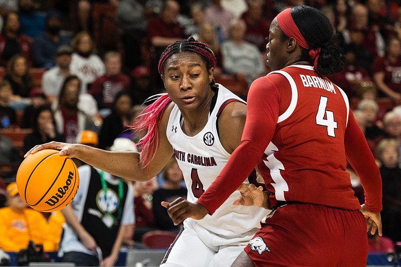 South Carolina's Aliyah Boston (4) dribbles past Arkansas' Erynn Barnum (4) in the first half of an NCAA college basketball game during the Southeastern Conference women's tournament in Greenville, S.C., Friday, March 3, 2023. (AP Photo/Mic Smith)