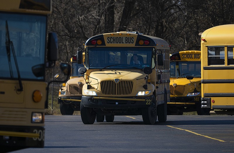 School busses make their way to pick up school children, Friday, January 20, 2023 from the Bentonville Schools bus barn in Bentonville. (NWA Democrat-Gazette/Charlie Kaijo)