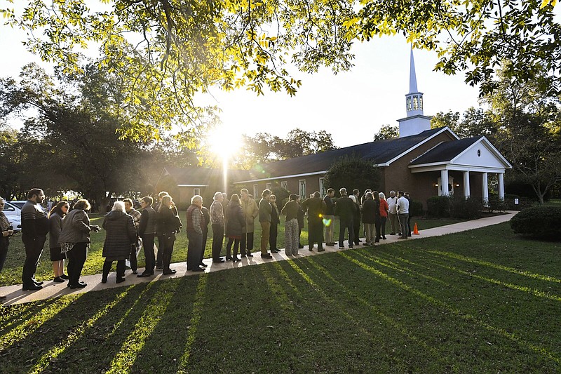 The sun breaks the horizon as guests line up in 2019 to attend a Sunday School class being taught by former President Jimmy Carter at Maranatha Baptist Church, in Plains, Ga. Visitors arrived before dawn in hopes of getting a seat inside.
(AP/John Amis)