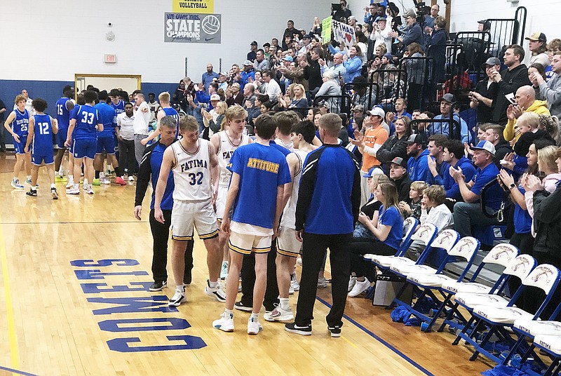 Nate Brandt (32) is acknowledged by Fatima teammates and fans in the final minute of Friday night's Class 4 District 9 Tournament title game against Father Tolton in Westphalia. (Tom Rackers/News Tribune)