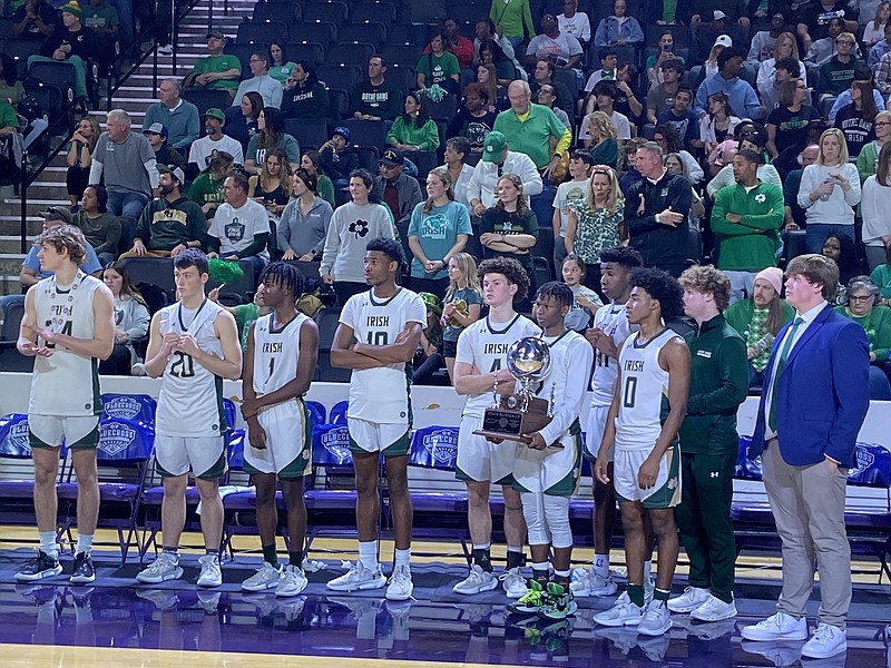 Staff photo by Stephen Hargis / Notre Dame players stand on the sideline after receiving their runner-up trophy Saturday at Tennessee Tech, where they lost to Goodpasture in the TSSAA Division II-A final at the BlueCross Basketball State Championships.