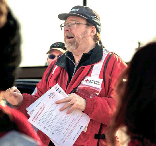 Josh Cobb/News Tribune photo: John Dungin briefs volunteers Saturday, March 4, 2023, before installing free smoke alarms. Members of the Red Cross traveled to Holts Summit to install free smoke alarms in some mobile homes.