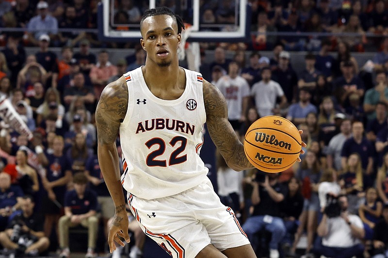 Auburn guard Allen Flanigan dribbles the ball against Tennessee during the second half of an NCAA college basketball game Saturday, March 4, 2023, in Auburn, Ala. (AP Photo/Butch Dill)