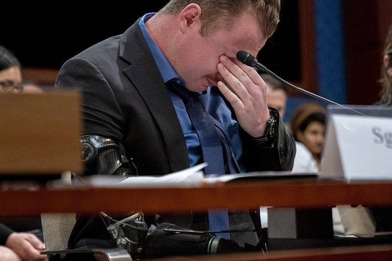 Marine Sgt. Tyler Vargas-Andrews, who was gravely injured, losing an arm and a leg in a suicide attack at Hamid Karzai International Airport in Kabul, becomes emotional as he recounts his story during a House Committee on Foreign Affairs hearing on the United States evacuation from Afghanistan on Capitol Hill in Washington, Wednesday, March 8, 2023. (AP Photo/Andrew Harnik)