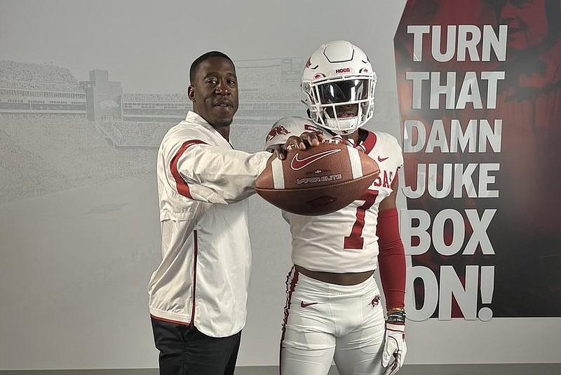 Arkansas running backs coach Jimmy Smith and 2025 running back DJ Dugar Jr. Arkansas running backs coach Jimmy Smith and 2025 running back DJ Dugar Jr.