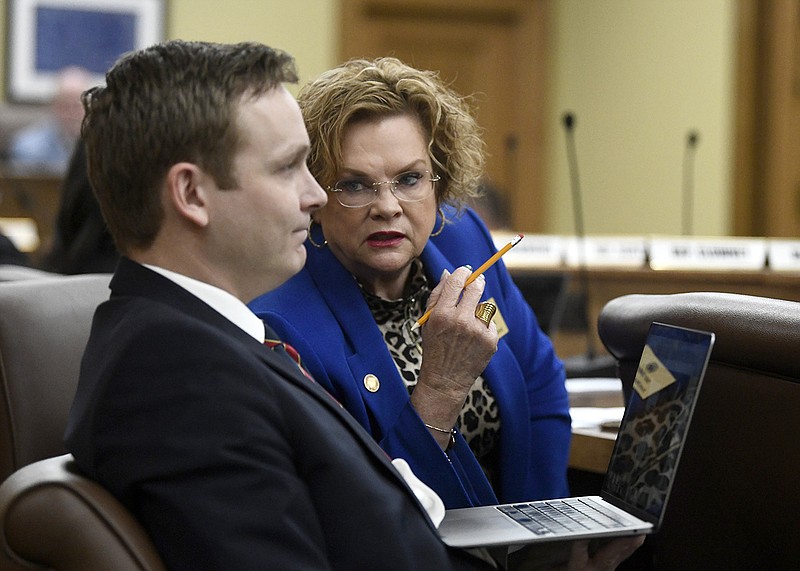 Arkansas Rep. Cindy Crawford, R-Fort Smith, talks with Rep. Jeremiah Moore, R-Clarendon, during presentation of House Bill 1537, which would allow electronic voter registration, during a meeting of the House Committee on State Agencies and Governmental Affairs at the state Capitol on Wednesday.
(Arkansas Democrat-Gazette/Stephen Swofford)