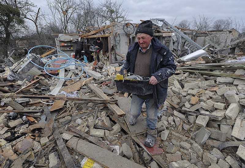 Villagers clean up Thursday after Russia’s missile barrage the night before in the Zolochevsky district of Ukraine’s western Lviv region, far from the front lines. More photos at arkansasonline.com/310ukraine/.
(AP/Mykola Tys)