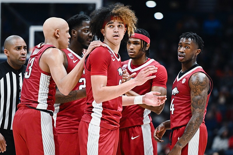 Arkansas players huddle on Thursday, March 9, 2023, during the first half of a game against Auburn in the 2023 SEC Men’s Basketball Tournament at Bridgestone Arena in Nashville, Tenn.