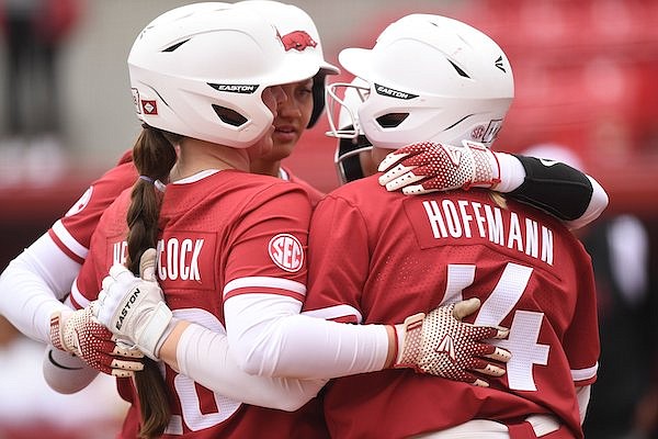 Arkansas designated player Rylin Hedgecock (left) celebrates Thursday, March 2, 2023, with Reagan Johnson, Kacie Hoffmann and Cylie Halvorson after hitting a two-run home run scoring Johnson during the third inning of the Razorbacks’ 4-0 win over Iowa State at Bogle Park in Fayetteville.