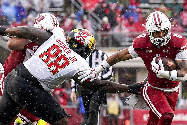 Wisconsin running back Braelon Allen (0) gets past Maryland defensive lineman Anthony Booker (88) during the first half of an NCAA college football game Saturday, Nov. 5, 2022, in Madison, Wis. (AP Photo/Andy Manis)