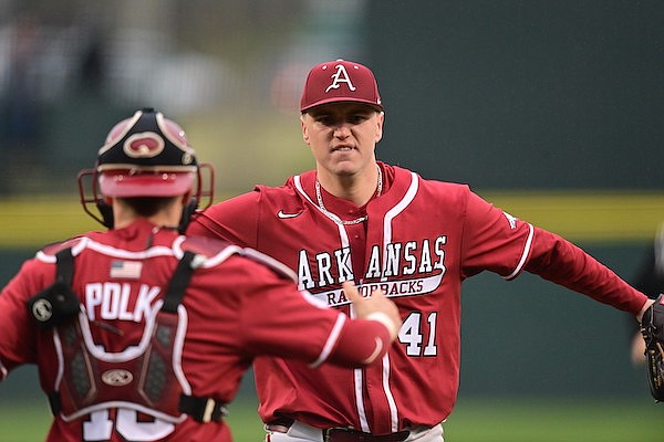 Arkansas pitcher Will McEntire (41) celebrates with catcher Hudson Polk after recording the final out of a 6-1 victory over Louisiana Tech on Saturday, March 11, 2023, in Fayetteville. McEntire pitched a complete game.