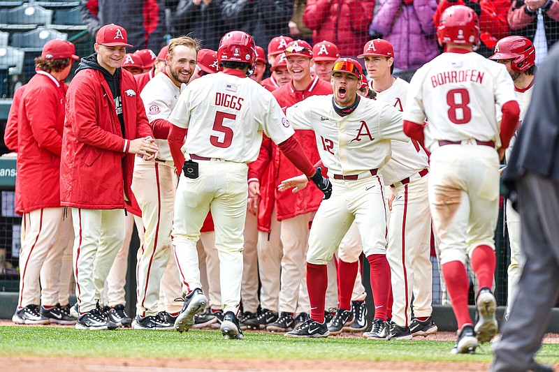 Arkansas Kendall Diggs (5) celebrates with teammates on his way back to the dugout after hitting a two-run home run, Sunday, March 12, 2023, during the third inning of the Razorbacks’s 15-6 win over the Louisiana Tech Bulldogs at Baum-Walker Stadium in Fayetteville. Visit nwaonline.com/photo for today's photo gallery..(NWA Democrat-Gazette/Hank Layton)