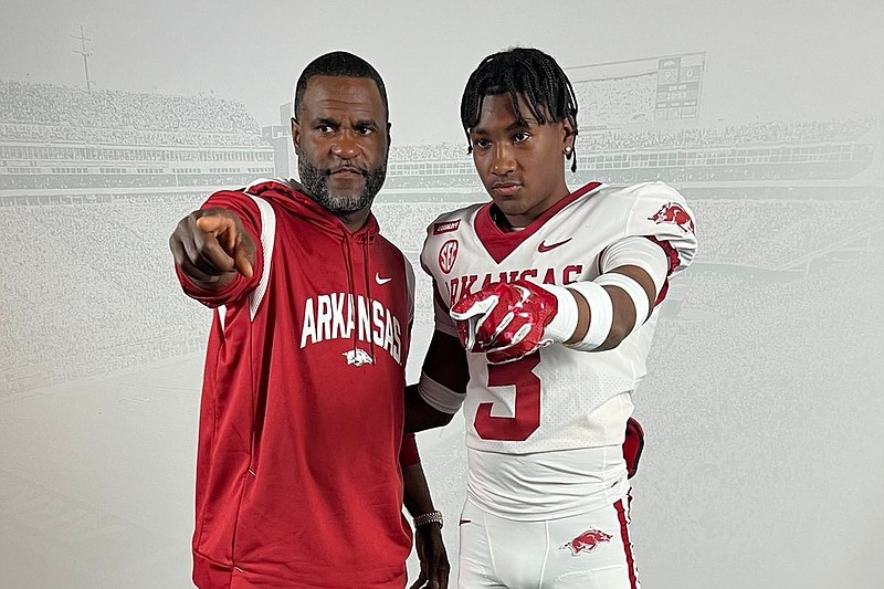 Arkansas co-defensive coordinator Marcus Woodson and 2026 athlete Shavar Young.