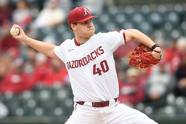 Caption: Arkansas starter Ben Bybee delivers to the plate Tuesday, Feb. 21, 2023, during the Razorbacks’ 9-7 win over Grambling at Baum-Walker Stadium in Fayetteville.