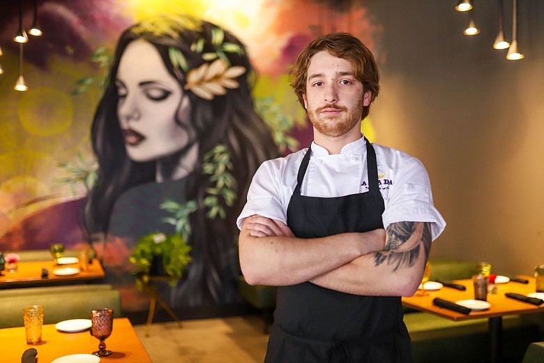 Staff photo by Olivia Ross  / Chef Adam Lawson of Amada poses for a photo in the dining area on Monday, February 13, 2023