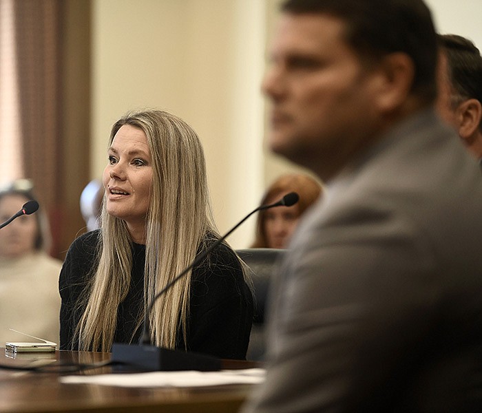 Melissa Harris (left) speaks in favor of Senate Bill 377, which would regulate paid petition blockers, during a meeting of the Senate Committee on Judiciary at the state Capitol in Little Rock on Wednesday. Harris described her time as a paid canvasser when she was harassed and threatened by petition blockers.
(Arkansas Democrat-Gazette/Stephen Swofford)