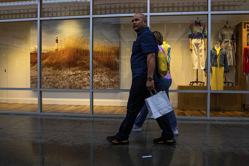 Shoppers pass a window display in Las Vegas on Tuesday.
(AP/Ty O’Neil)