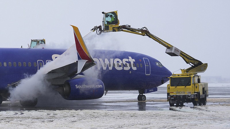A crew deices a Southwest Airlines jet at Salt Lake City International Airport in February.
(AP/Rick Bowmer)