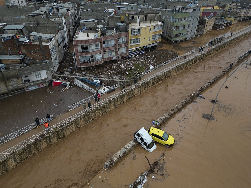 Vehicles and debris are scattered Wednesday during floods, after heavy rains in Sanliurfa, Turkey.
(AP/DIA/Hakan Akgun)