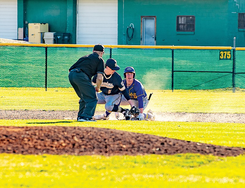 Fatima's Blake Gentges is safe at second base on a double as Helias second baseman Myles Gresham applies a tag during Jamboree action Tuesday at Vivion Field. (Ken Barnes/News Tribune)