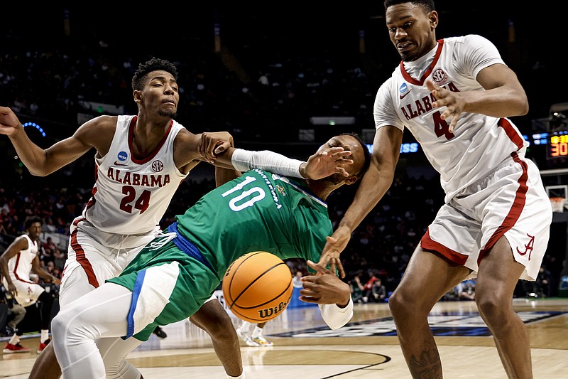 AP photo by Butch Dill / Texas A&M-Corpus Christi forward Isaac Mushila (10) is fouled by Alabama's Brandon Miller (24) as they reach for a rebound in the second half of their NCAA tournament first-round game Thursday in Birmingham, Ala. Miller was held scoreless, but the Crimson Tide cruised to a 96-75 victory.