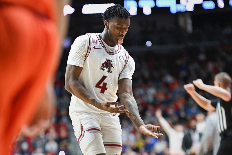 Arkansas guard Davonte Davis (4) reacts after scoring a three, Thursday, March 16, 2023 during the second half of the NCAA Division I Basketball Championship First Round game at the Wells Fargo Arena in Des Moines, Iowa. Visit nwaonline.com/photos for the photo gallery.