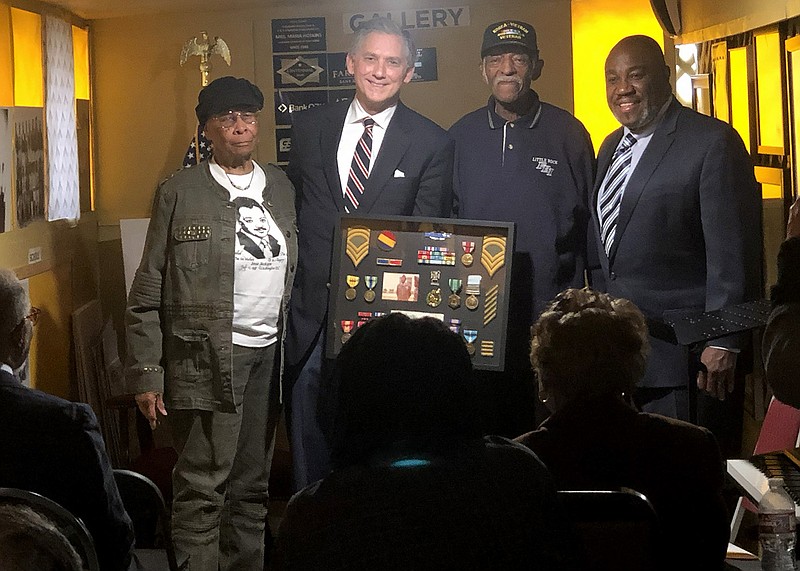 U.S. Rep. French Hill (second from left) presents retired Army Master Sgt. Alvin Gill (second from right) with a shadowbox of military awards he earned over his 20-year career during a ceremony in Mayflower Thursday morning. Gill was joined by his wife, Berthenia (left), and Roger Evans (right).
(Arkansas Democrat-Gazette/Daniel McFadin)