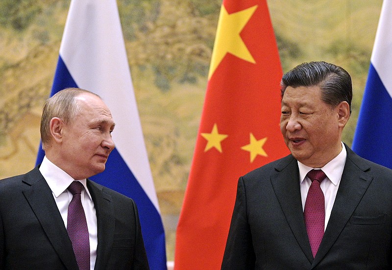 FILE - Chinese President Xi Jinping, right, and Russian President Vladimir Putin talk to each other during their meeting in Beijing, China on Feb. 4, 2022. China says President Xi will visit Russia from Monday, March 20, to Wednesday, March 22, 2023, in an apparent show of support for Russian President Putin amid sharpening east-west tensions over the conflict in Ukraine. (Alexei Druzhinin, Sputnik, Kremlin Pool Photo via AP, File)
