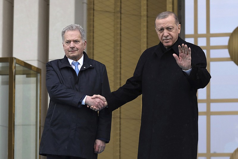 Turkish President Recep Tayyip Erdogan, right, and Finland's President Sauli Niinisto shake hands during a welcome ceremony at the presidential palace in Ankara, Turkey, Friday, March 17, 2023. Erdogan greeted his Finnish counterpart in Ankara on Friday amid hopes that their meeting will see Turkey approve Finland's NATO membership bid. (AP Photo/Burhan Ozbilici)