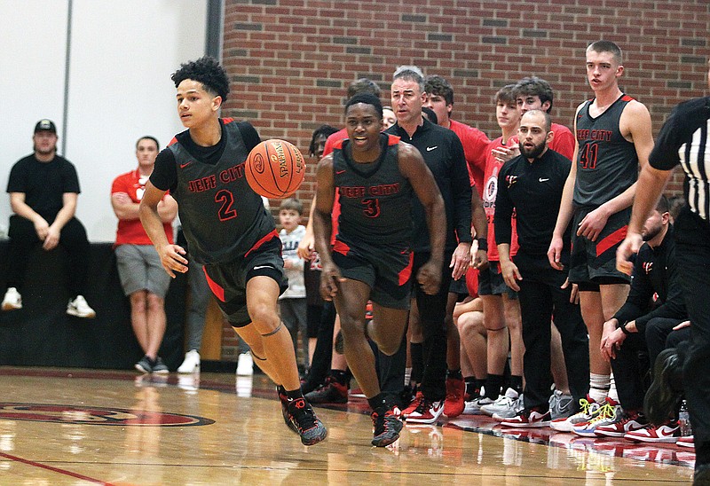 Jefferson City's Kendric Johnson brings the ball up the court ahead of teammate Steven Samuels during a game earlier this season at Fleming Fieldhouse. (Greg Jackson/News Tribune)