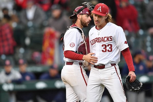 Arkansas reliever Hagen Smith celebrates the final out of the game Friday, March 17, 2023, with catcher Parker Rowland during the Razorbacks’ 7-2 win over Auburn at Baum-Walker Stadium in Fayetteville.