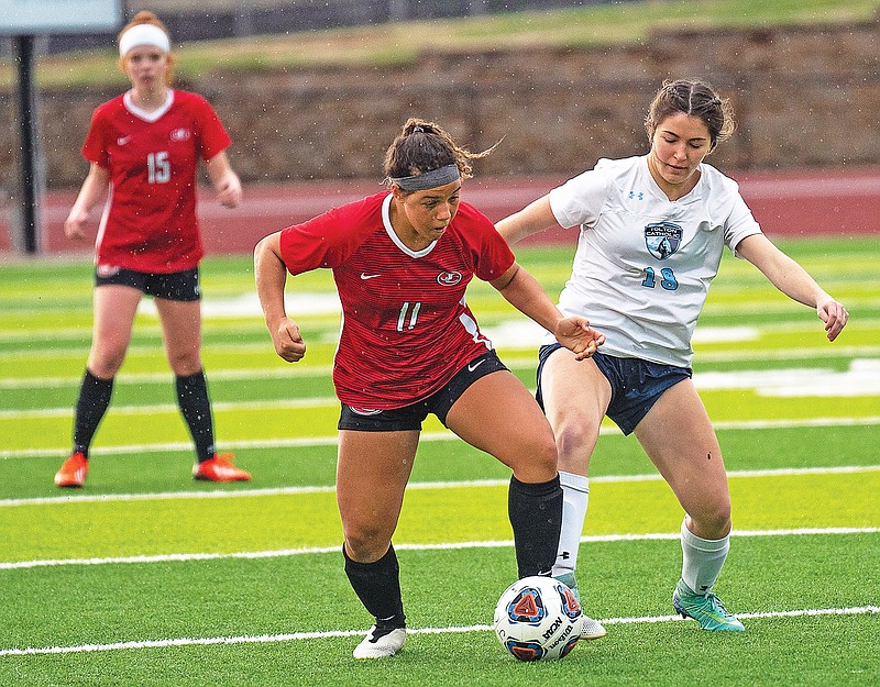 Jefferson City's Jada Barlow fights for control of the ball during action against Father Tolton last season at Adkins Stadium. (News Tribune file photo)