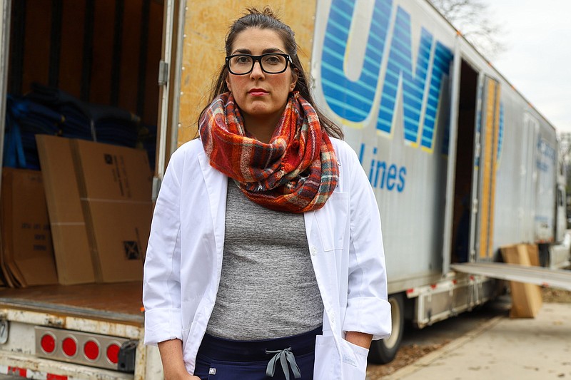 Staff photo by Olivia Ross  / Dr. Leilah Zahedi-Spung stands next to their moving truck on December 21, 2022. Zahedi-Spung, a maternal fetal medicine specialist, is moving from Chattanooga to Colorado and will continue her practice.