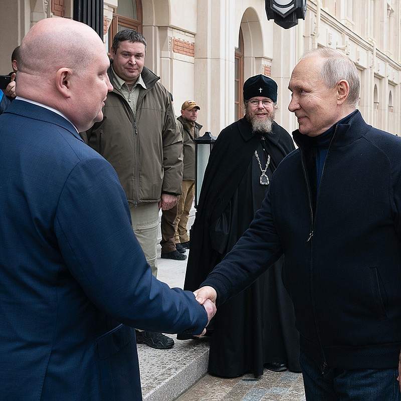 Russian President Vladimir Putin shakes hands with Mikhail Razvozhayev, governor of Sevastopol, as he arrives Saturday to visit the Children’s Art and Aesthetic center in Sevastopol, Crimea. More photos at arkansasonline.com/ukrainemonth13/.
(AP/Sputnik, Kremlin Press Service)