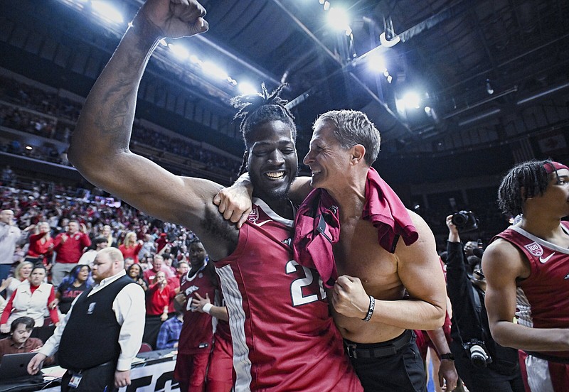 Arkansas forward/center Makhel Mitchell (left) and Coach Eric Musselman celebrate after the Razorbacks defeated Kansas 72-71 in an NCAA Men’s Tournament second-round game Saturday at the Wells Fargo Arena in Des Moines, Iowa. More photos at arkansasonline.com/319uaku/
(NWA Democrat-Gazette/Charlie Kaijo)