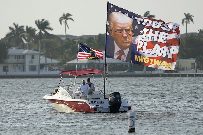 Supporters of former President Donald Trump fly a flag from a boat reading “Trust the Plan” Saturday outside of Trump’s Mar-a-Lago estate in Palm Beach, Fla.
(AP/Lynne Sladky)