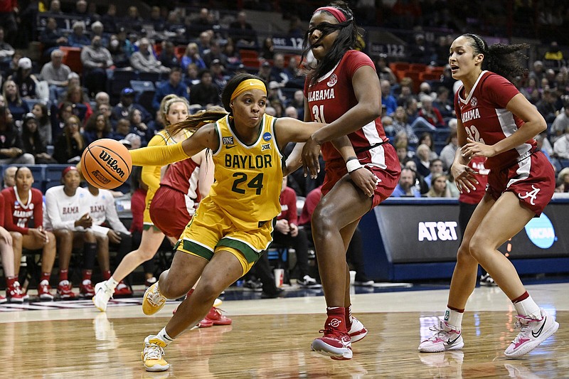 Baylor’s Sarah Andrews (left) dribbles around Alabama’s Jada Rice during a first-round NCAA Women’s Tournament game on Saturday in Storrs, Conn. Baylor won 78-74 and will take on UConn on Monday.
(AP/Jessica Hill)