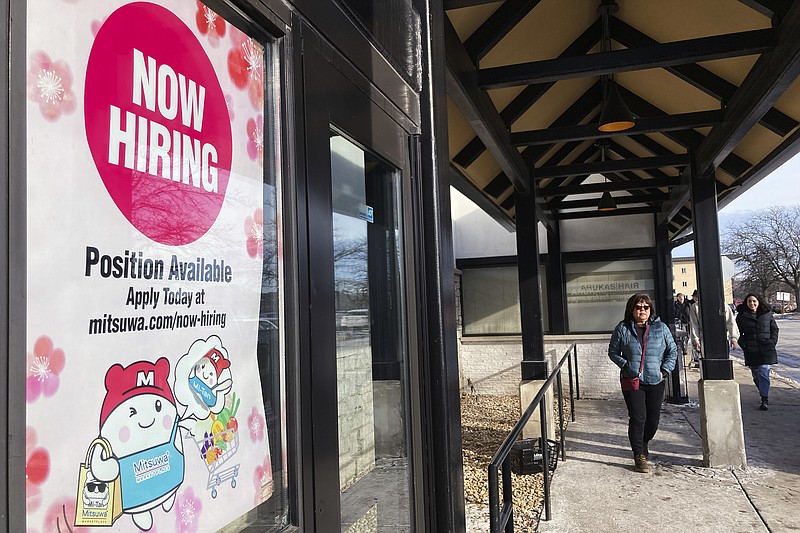 File - A hiring sign is displayed at a grocery store in Arlington Heights, Ill., Tuesday, Dec. 27, 2022.(AP Photo/Nam Y. Huh, File)