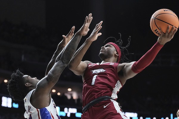 Arkansas' Ricky Council shoots past Kansas' K.J. Adams Jr. during the second half of a second-round college basketball game in the NCAA Tournament Saturday, March 18, 2023, in Des Moines, Iowa. (AP Photo/Morry Gash)