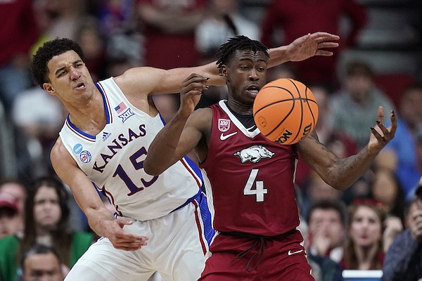 Arkansas guard Davonte Davis (4) is fouled by Kansas guard Kevin McCullar Jr. (15) in the second half of a second-round college basketball game in the NCAA Tournament, Saturday, March 18, 2023, in Des Moines, Iowa. (AP Photo/Charlie Neibergall)